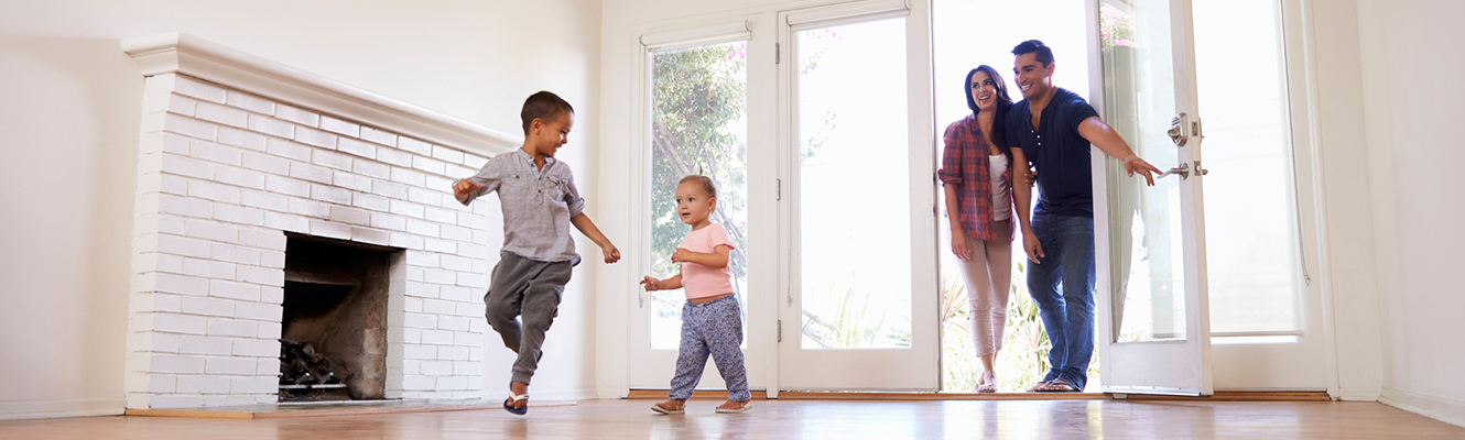 Family entering a new house