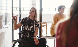 Disabled lady in a wheelchair in a meeting