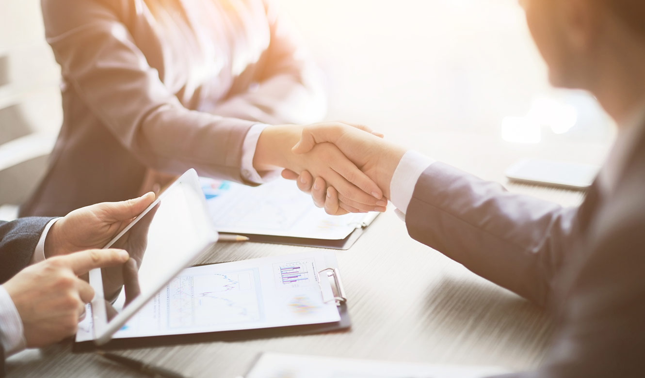 Two business people shaking hands.